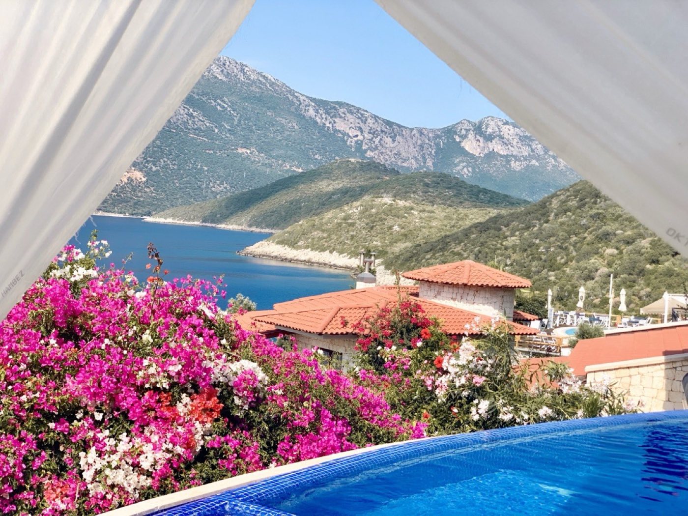 Pool terrace above Bucak Bay with bougainvillea and the Kaş mountains