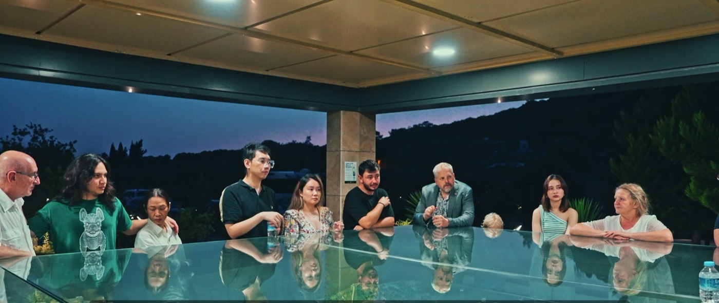 Guests around a terrace table at dusk