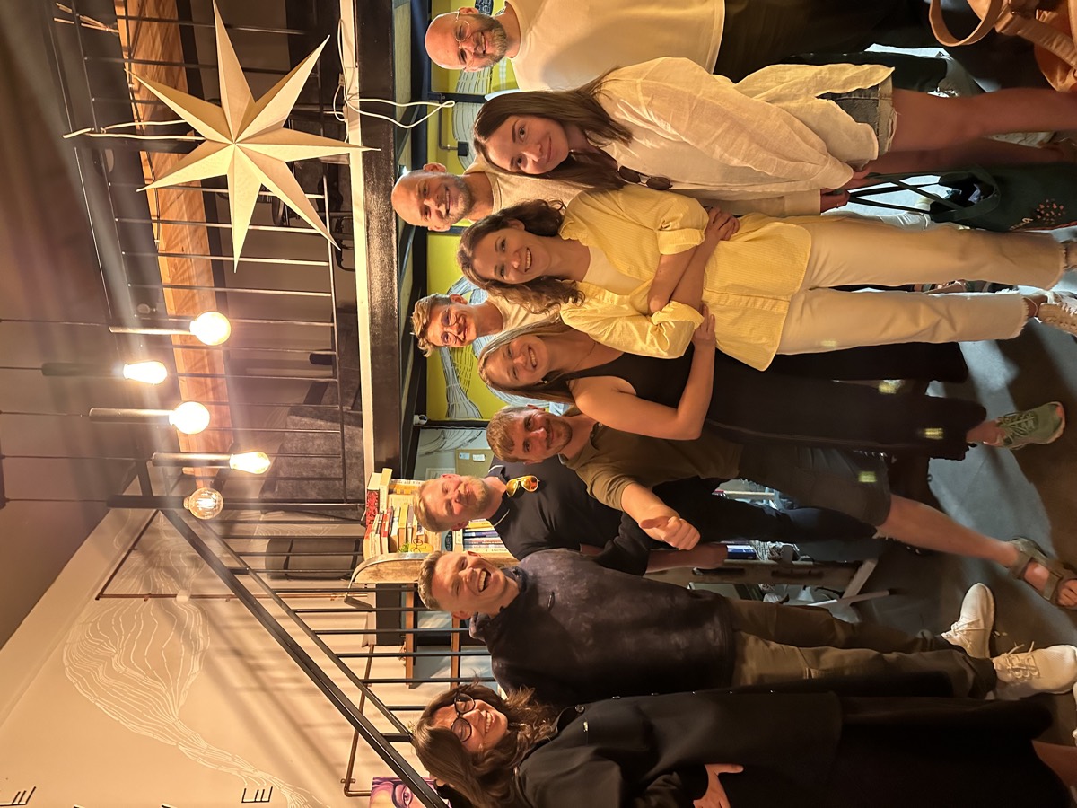 Smiling community group under the paper star