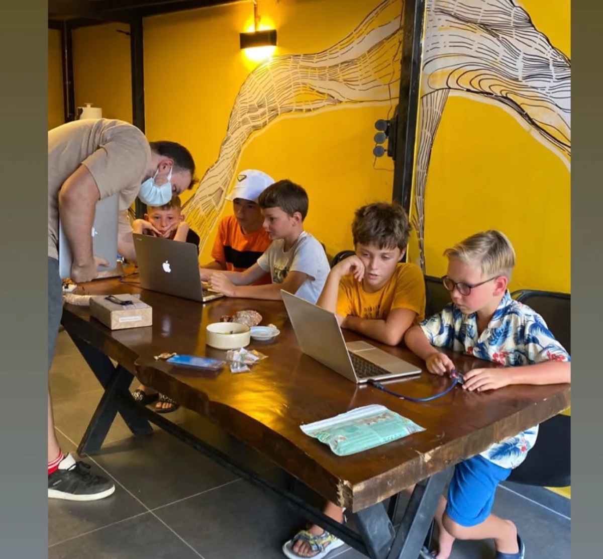 Kids learning to code on laptops