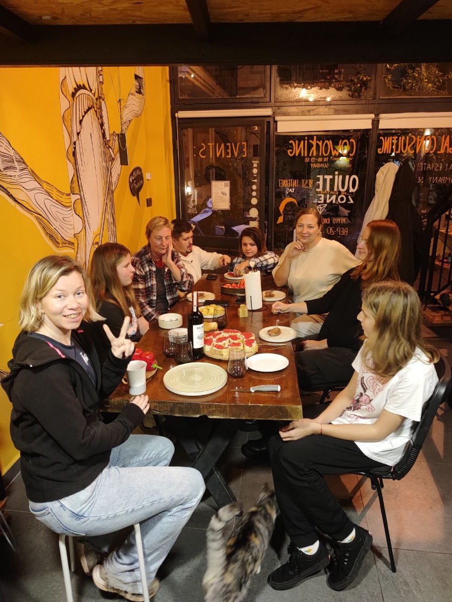 Pizza night with friends flashing peace signs